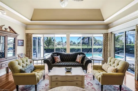 a living room with furniture a rug and a chandelier
