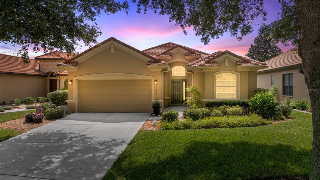 2053 North Lakecrest Loop Hernando, FL 34442 - Photo 1 of 1 a front view of a house with a garden