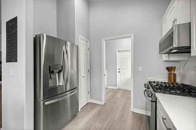an aerial view of a house with a garden and lake view