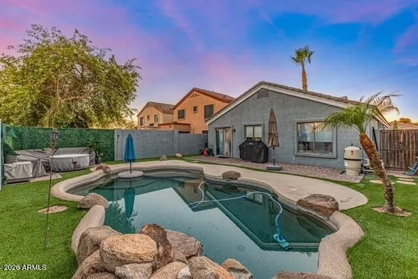 a view of a house with swimming pool and sitting area