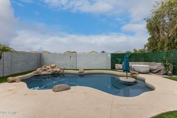 a view of a swimming pool and lounge chair