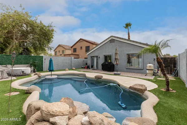 a view of a house with swimming pool and sitting area