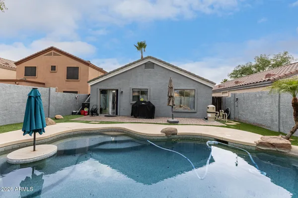 a swimming pool view with a outdoor seating