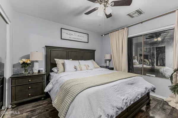a bedroom with a bed and wooden floor