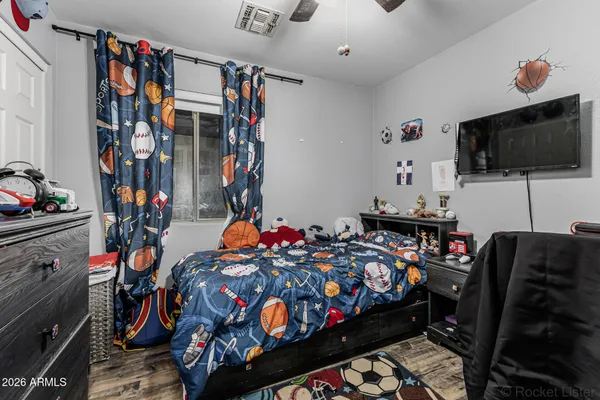 a bedroom with furniture and a flat screen tv