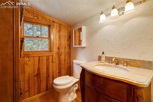 a bathroom with a sink a toilet and shower curtain