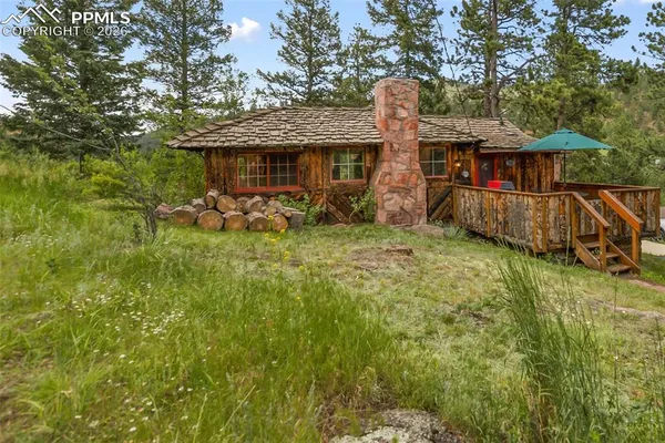 a front view of house with yard having outdoor seating