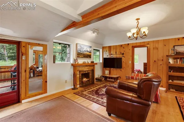 a living room with furniture a fireplace and a flat screen tv