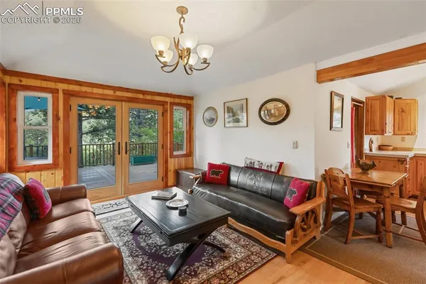 a living room with furniture a clock and a large window