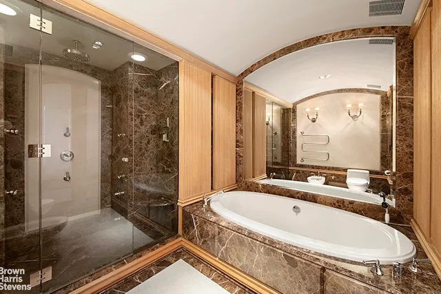 a bathroom with double vanity sink and a mirror