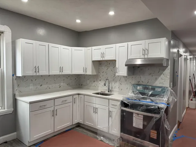a kitchen with a sink stove and cabinets