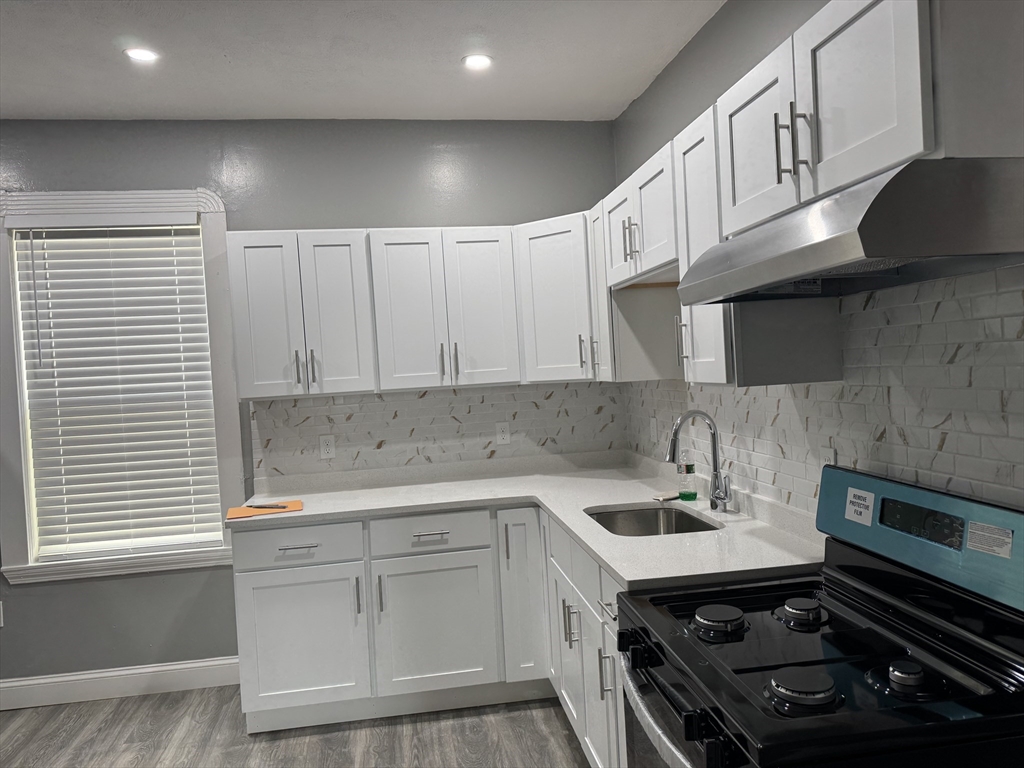 419 Seaver Street, Unit 3 Boston, MA 02121 - Photo 11 of 22 a kitchen with a sink appliances and cabinets