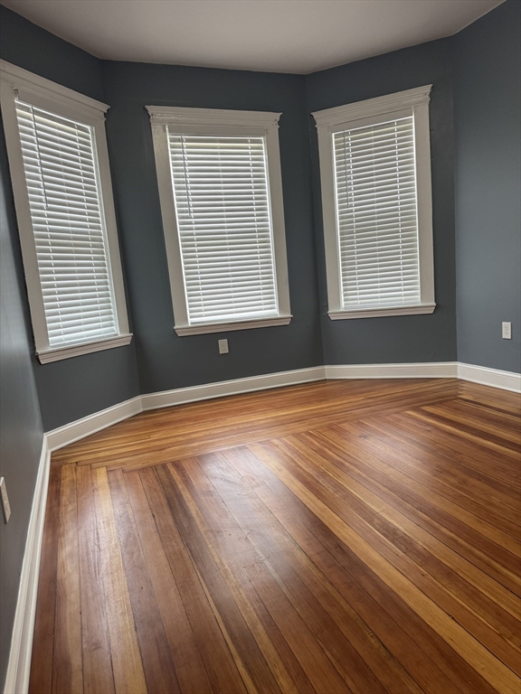 419 Seaver Street, Unit 3 Boston, MA 02121 - Photo 15 of 22 a view of an empty room with wooden floor and a window