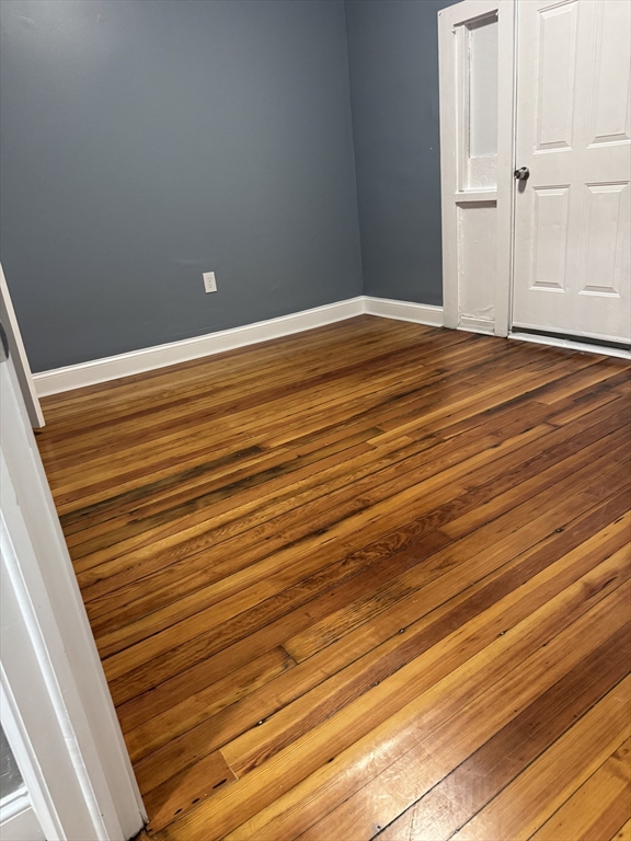 419 Seaver Street, Unit 3 Boston, MA 02121 - Photo 16 of 22 a view of empty room with wooden floor