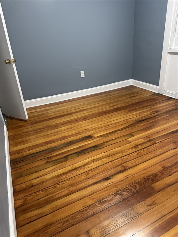 419 Seaver Street, Unit 3 Boston, MA 02121 - Photo 20 of 22 a view of empty room with wooden floor