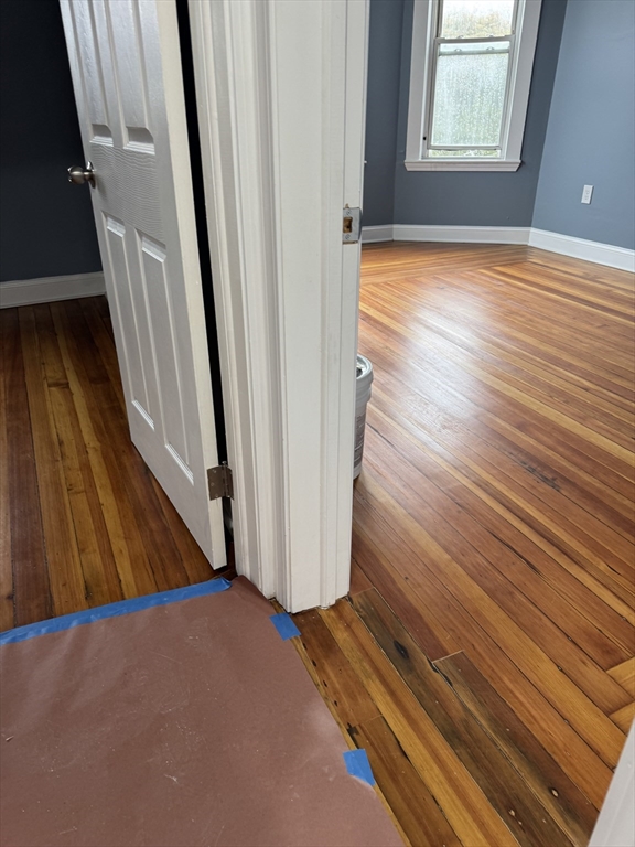419 Seaver Street, Unit 3 Boston, MA 02121 - Photo 4 of 22 a view of a hallway with wooden floor and staircase