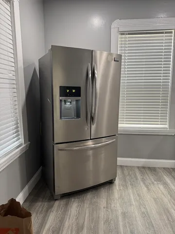 a kitchen with stainless steel appliances granite countertop a stove and a refrigerator