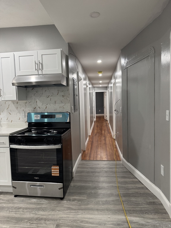 419 Seaver Street, Unit 3 Boston, MA 02121 - Photo 9 of 22 a kitchen with stainless steel appliances granite countertop a stove and a refrigerator