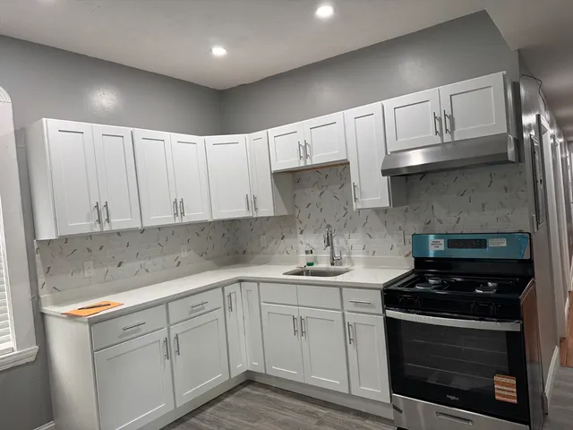 a kitchen with a sink appliances and cabinets