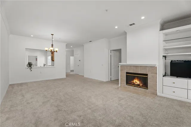 an empty room with fireplace and wooden floor