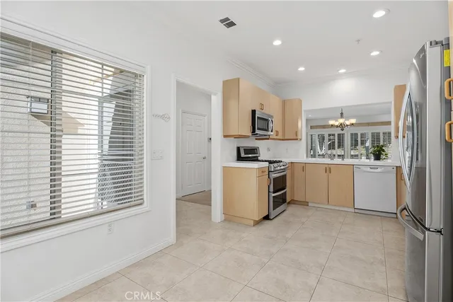 a kitchen with a refrigerator and a stove top oven