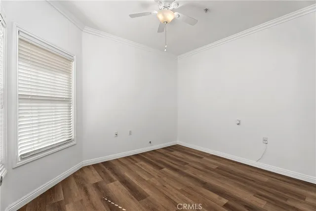 a view of a room with wooden floor and fan