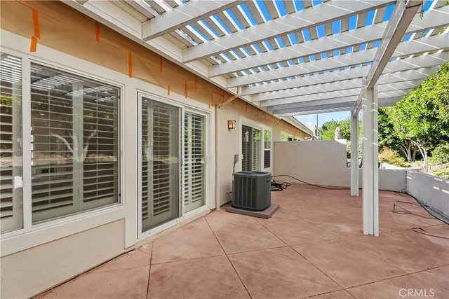 a view of a porch with furniture and garden