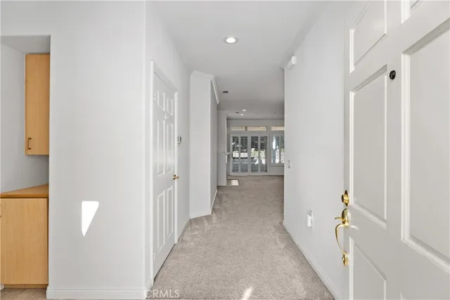 a view of a hallway with wooden shelves