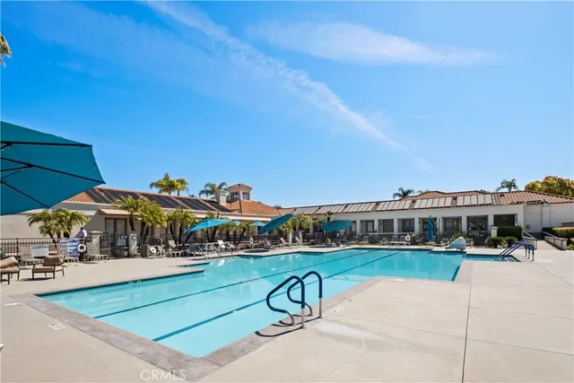 a view of swimming pool with a table and chairs