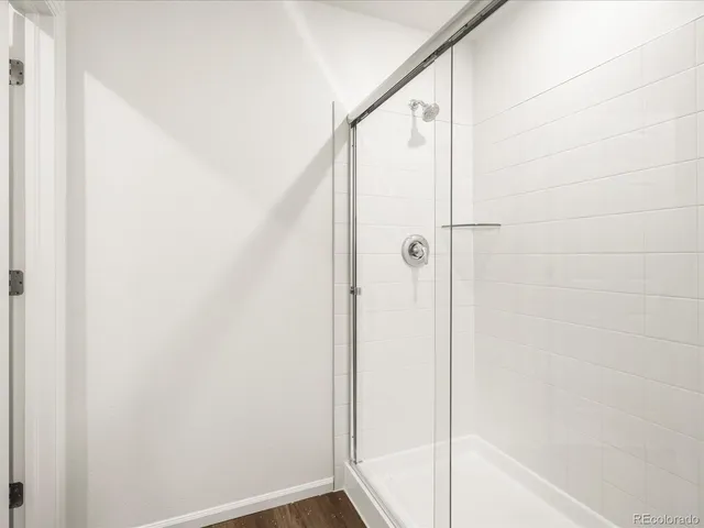 a bathroom with a glass shower door