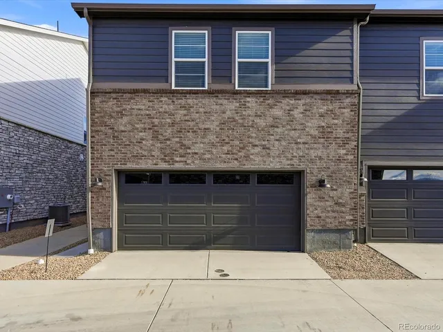 a front view of a house with garage