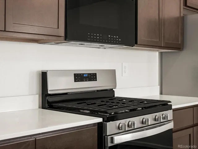 a stove top oven sitting inside of a kitchen