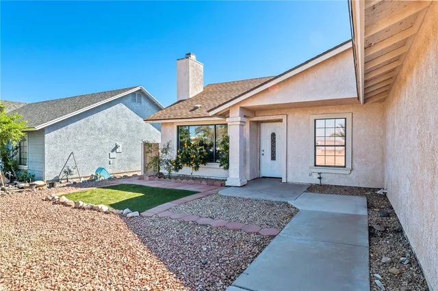 a view of a house with tub and trees in the background