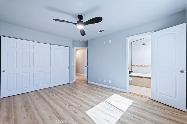 a bathroom with a granite countertop sink a toilet and a mirror