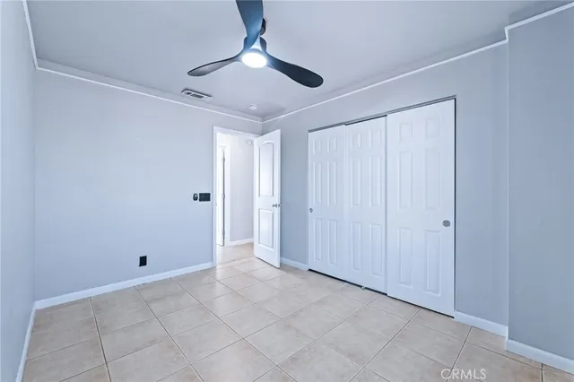 a view of a room with a ceiling fan