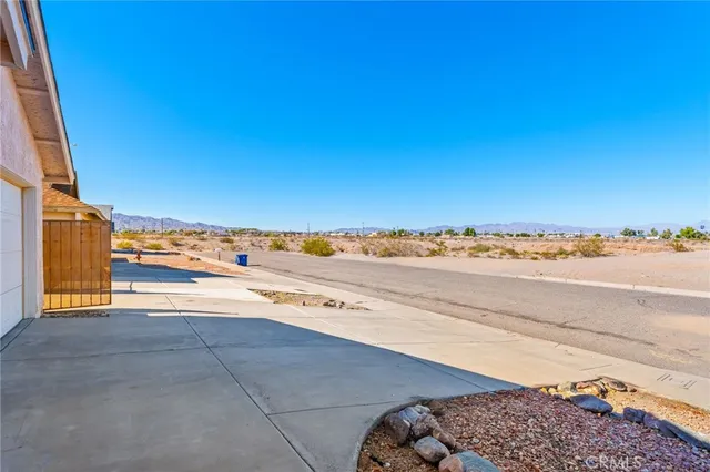 an empty room with windows and fireplace