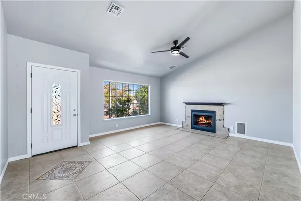a view of a livingroom with a fireplace and a ceiling fan