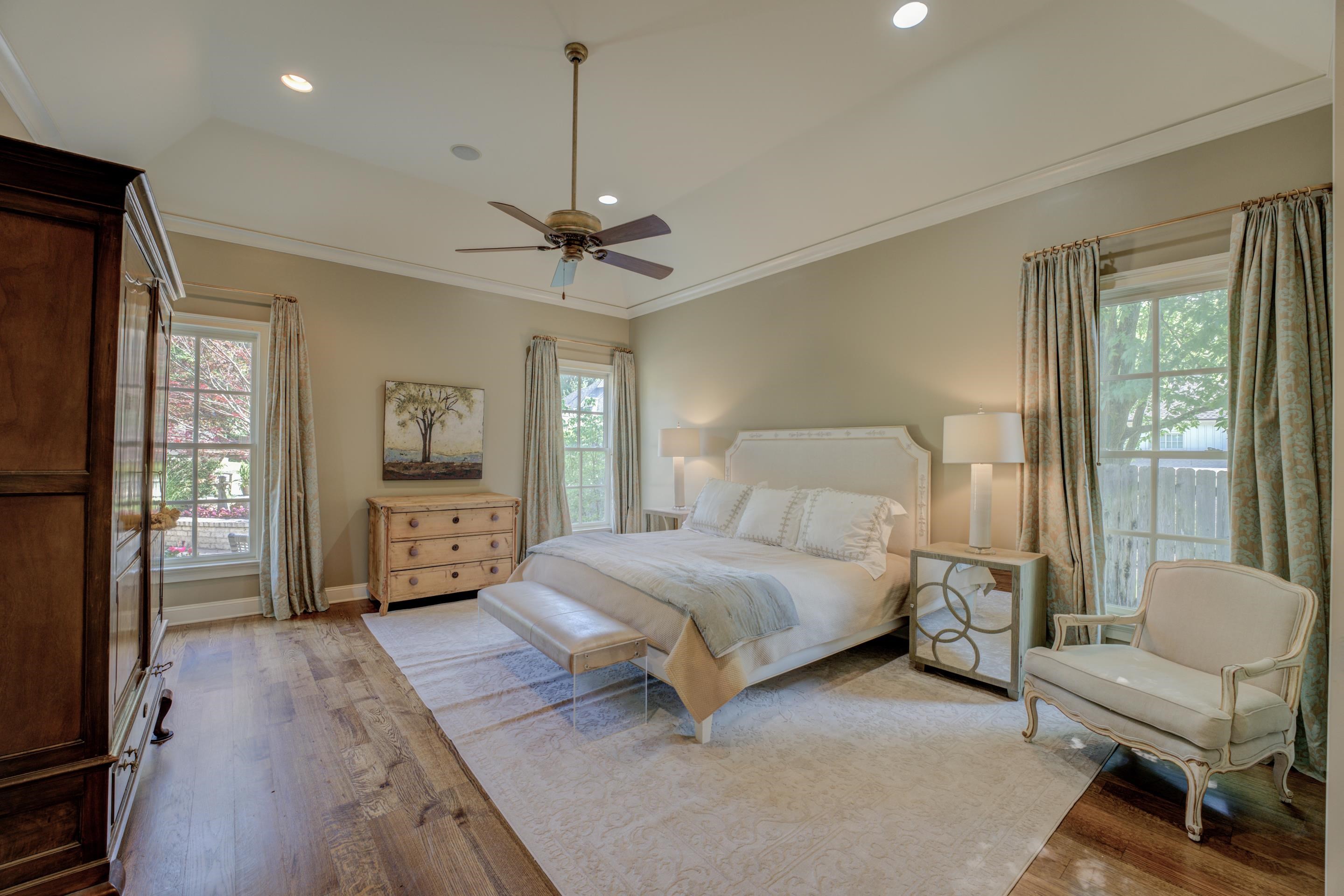 5074 Shady Grove Road Memphis, TN 38117 - Photo 11 of 25 Indulge in the epitome of luxury and relaxation within the downstairs primary suite with a soaring ceiling creating spaciousness and elegance. The walk-in closets offer ample storage space, ensuring that your personal belongings are neatly organized.