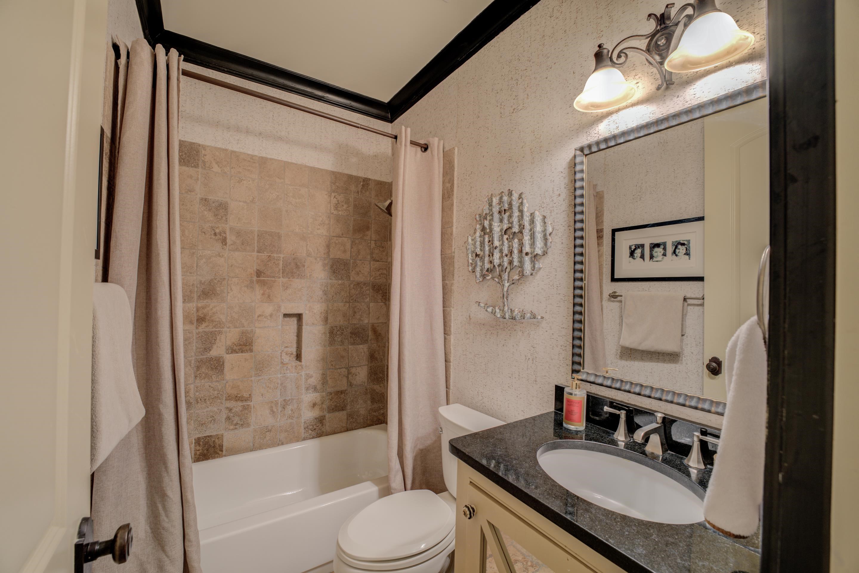 5074 Shady Grove Road Memphis, TN 38117 - Photo 15 of 25 This full bathroom is a sanctuary, a place where you can retreat from the world and indulge in moments of self-care and rejuvenation.
