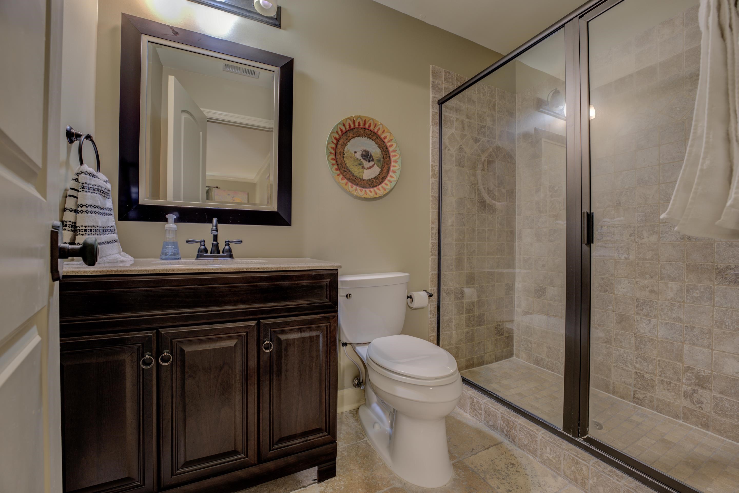 5074 Shady Grove Road Memphis, TN 38117 - Photo 18 of 25 The spacious walk-in shower beckons, adorned with elegant tiles and a sleek glass enclosure that adds a touch of modern sophistication.