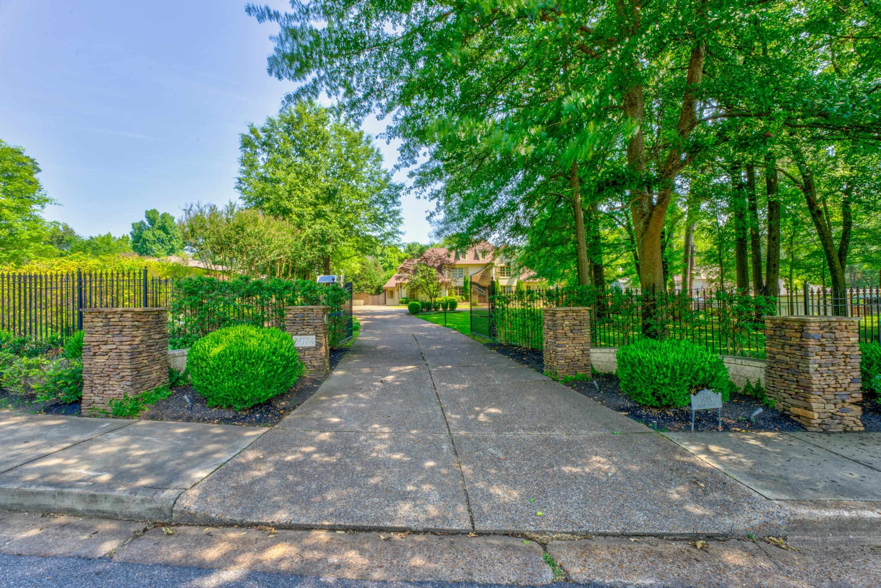 5074 Shady Grove Road Memphis, TN 38117 - Photo 23 of 25 As you approach the iron gated entrance, anticipation builds. Step into a private paradise that spans over .91 acres of meticulously landscaped grounds.