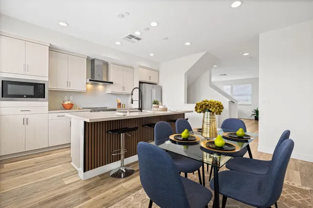 a kitchen with a table chairs and microwave