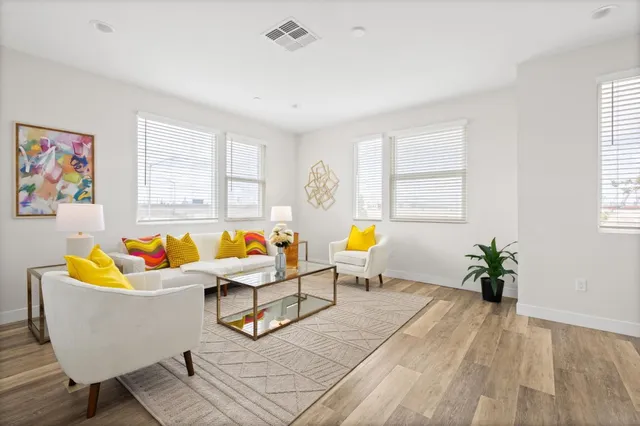 a living room with furniture and wooden floor