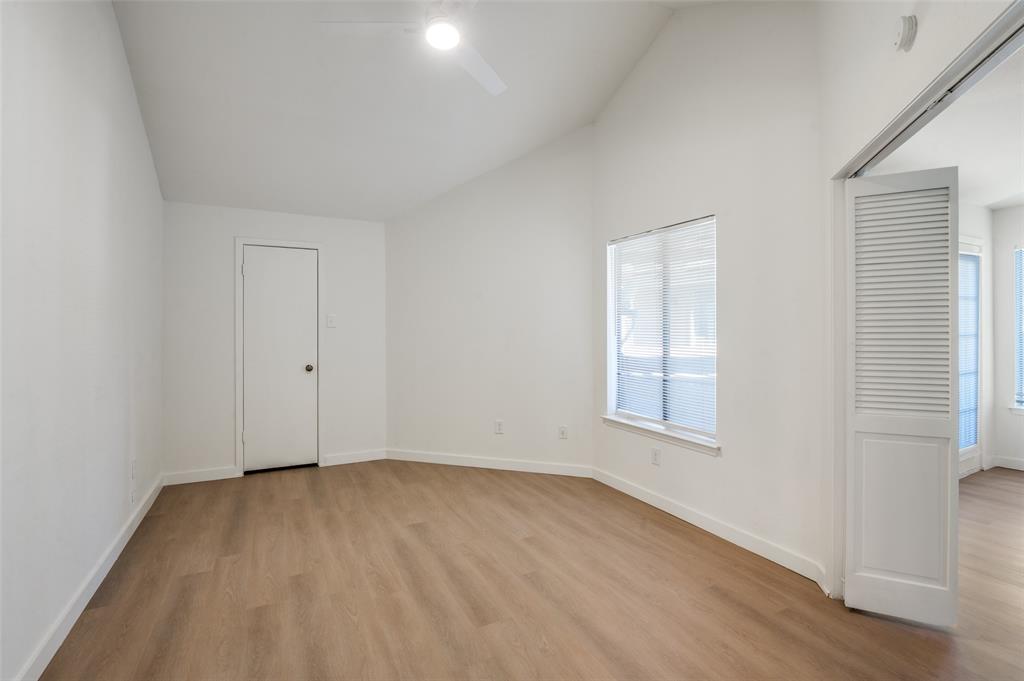 5550 Spring Valley Road, Unit D31 Dallas, TX 75254 - Photo 14 of 19 an empty room with wooden floor and windows