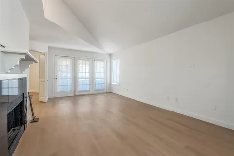 wooden floor in an empty room with a fireplace