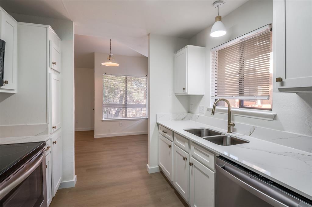 5550 Spring Valley Road, Unit D31 Dallas, TX 75254 - Photo 9 of 19 a kitchen that has a sink and a stove
