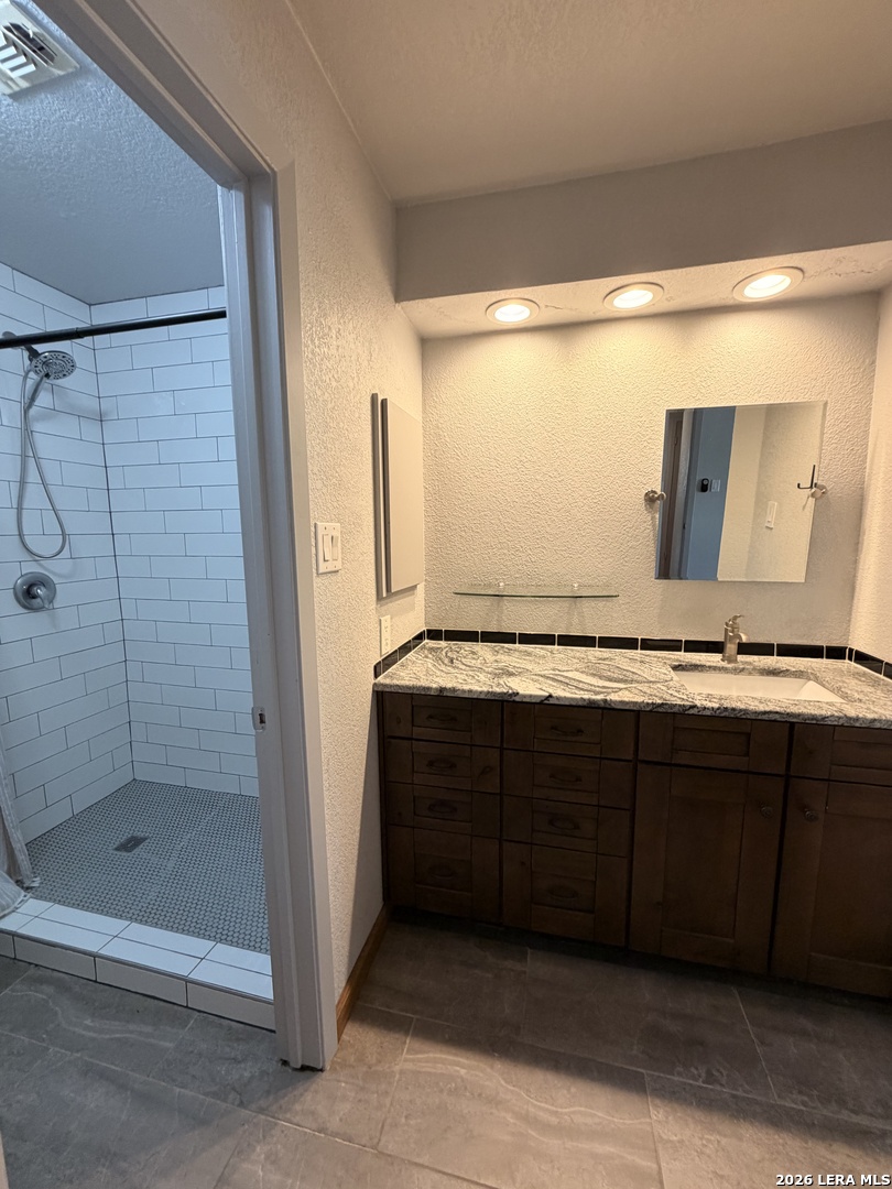 14343 Judson Road, Unit 302 San Antonio, TX 78233 - Photo 12 of 14 a bathroom with a sink and a mirror