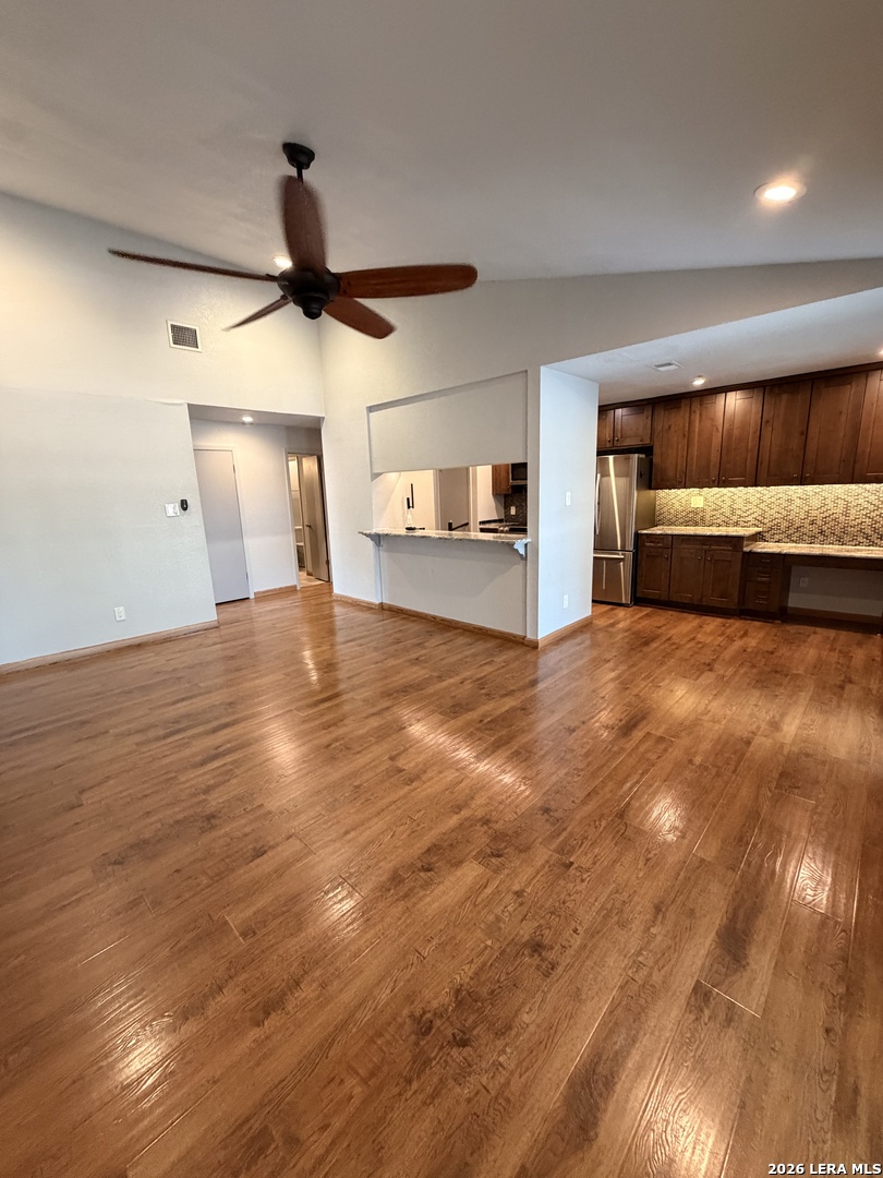 14343 Judson Road, Unit 302 San Antonio, TX 78233 - Photo 13 of 14 a view of a kitchen with a sink and dishwasher with wooden floor