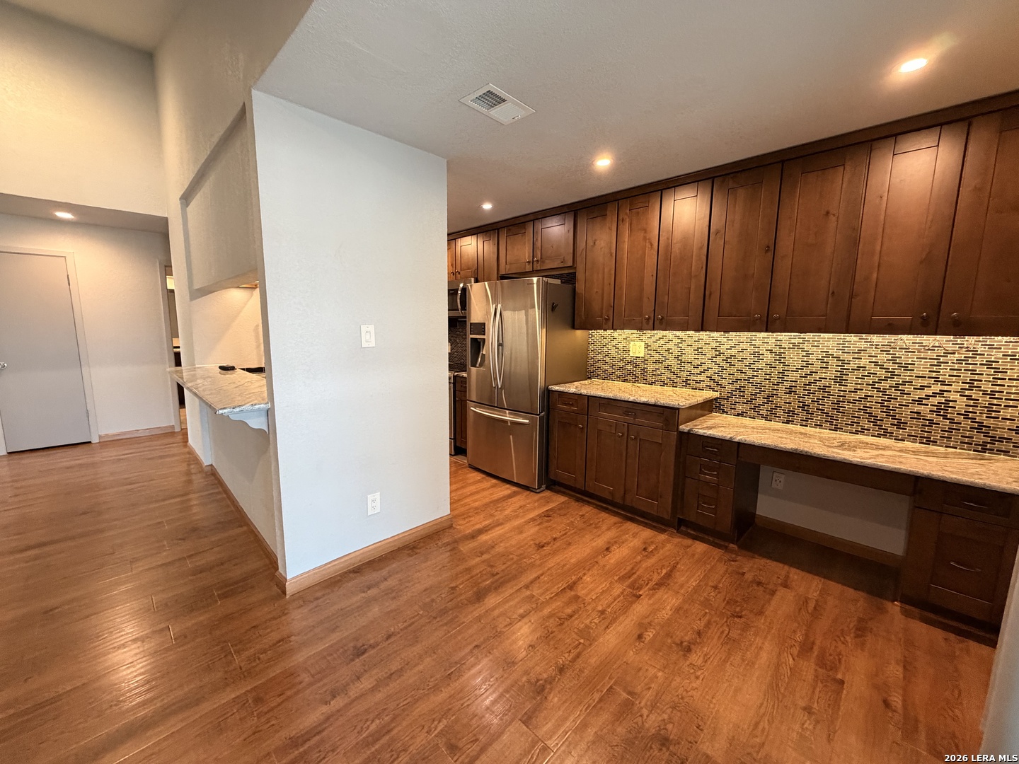 14343 Judson Road, Unit 302 San Antonio, TX 78233 - Photo 2 of 14 a kitchen with stainless steel appliances granite countertop wooden cabinets and wooden floor