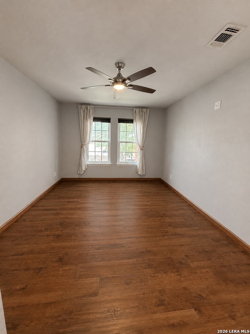14343 Judson Road, Unit 302 San Antonio, TX 78233 - Photo 4 of 14 wooden floor in an empty room with a window